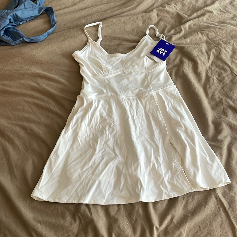 Brand New with tags white tennis dress with leg slit and built in shorts
